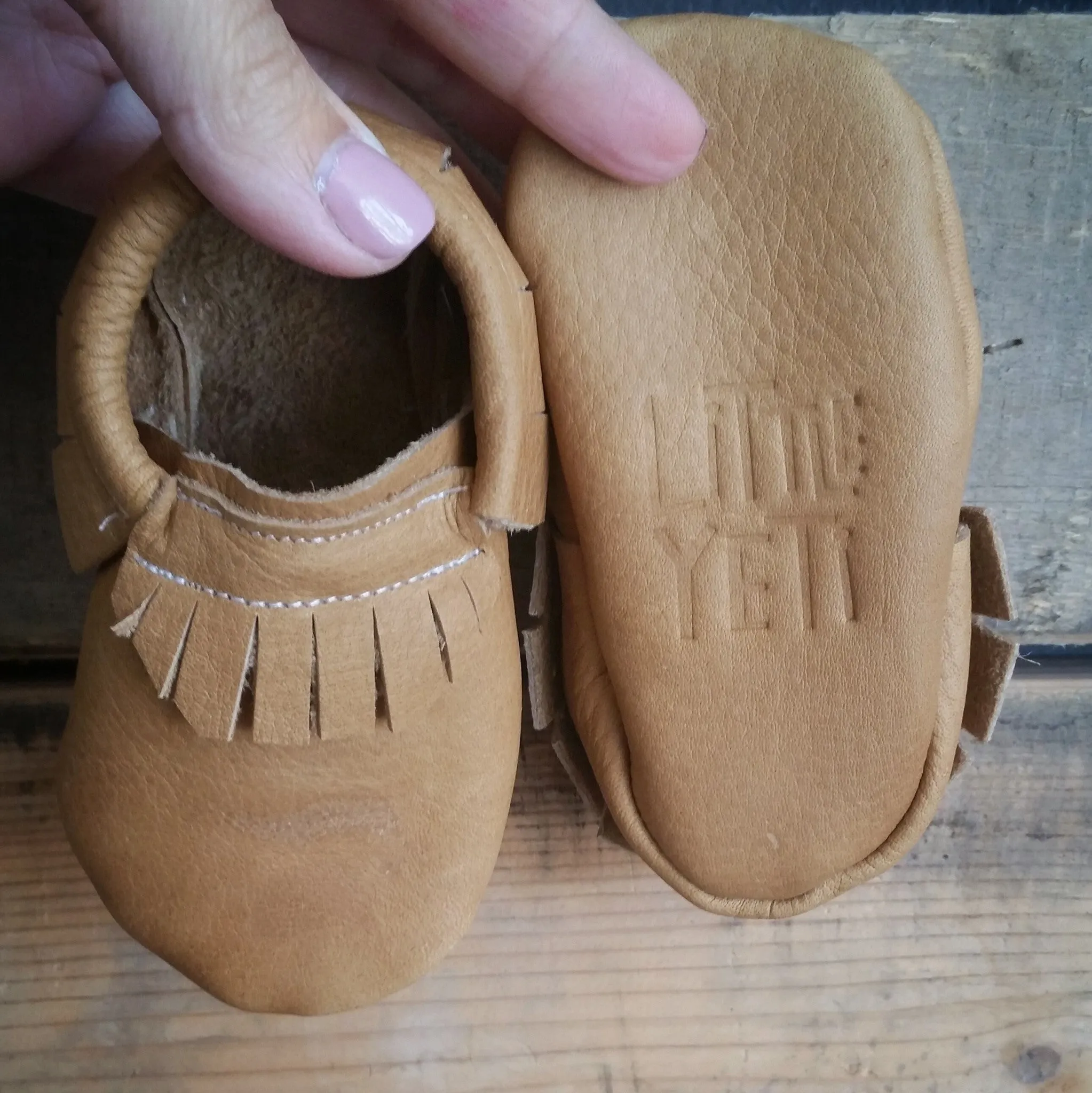 Tan mocc with short fringe